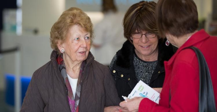 women talking to healthwatch representative